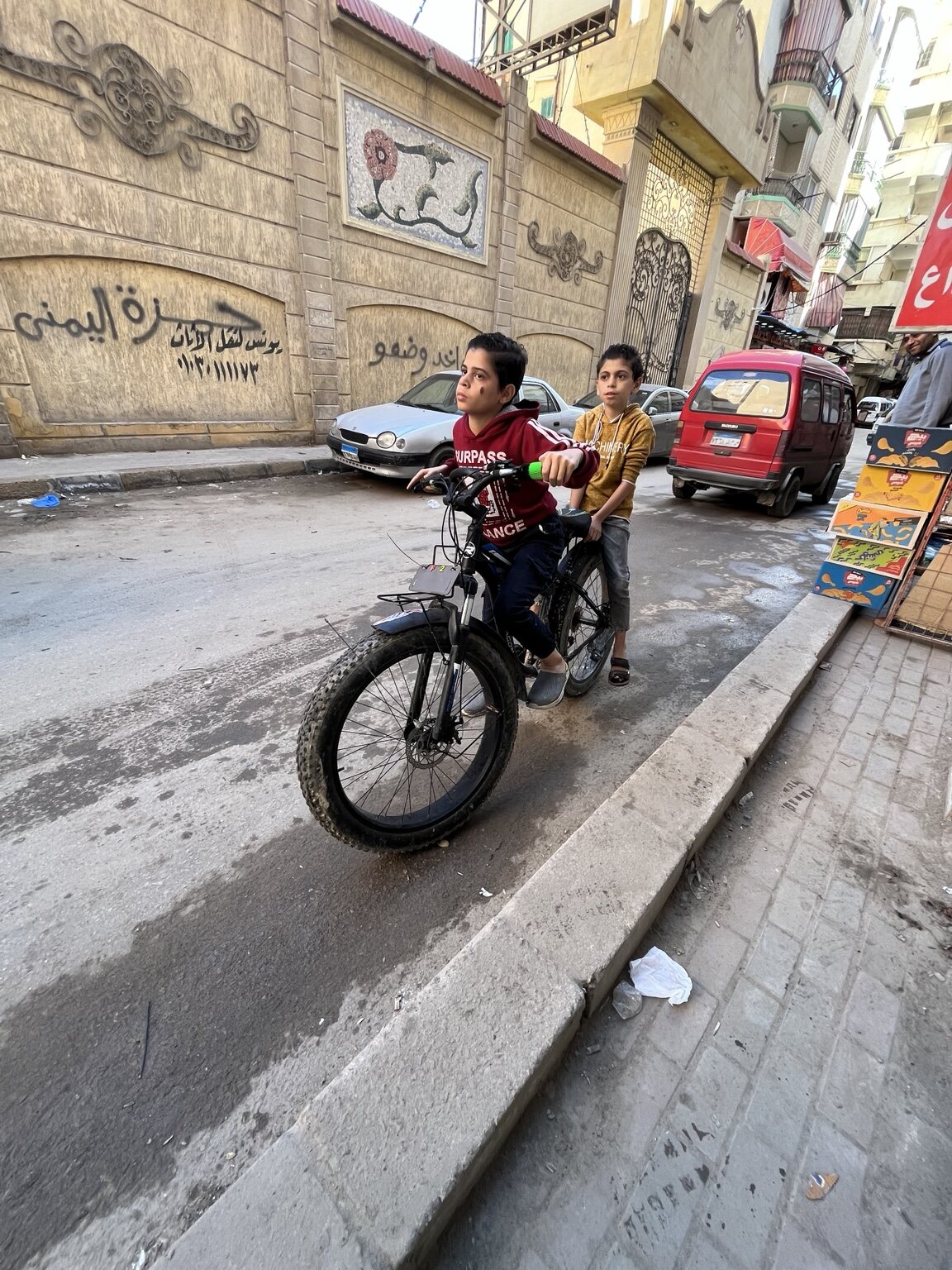 A motorcycle passing through a neighborhood street in Egypt