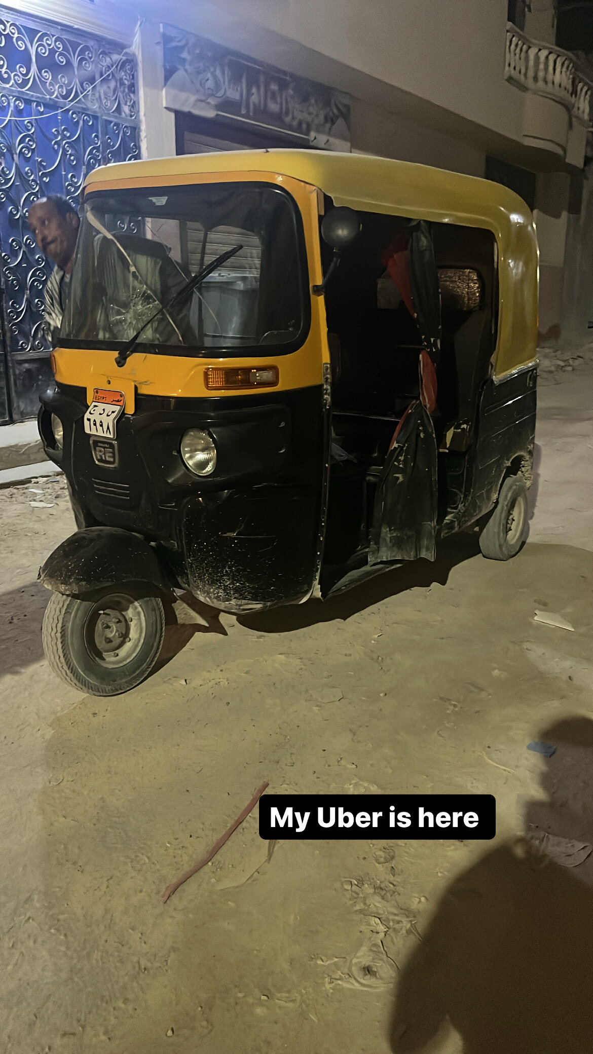 A tuk-tuk on an Egyptian street at night